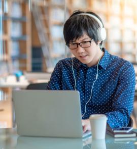 Man with headphones using a laptop