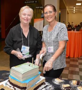 Two women assist at a library fundraiser